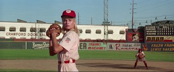 Movie still from “A League of Their Own” (1992), directed by Penny Marshall – A woman in a baseball uniform holding a baseball mitt; Medium shot, Low angle