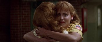 Movie still from “A League of Their Own” (1992), directed by Penny Marshall – Two women hugging each other in a room; Close Up shot, Over the shoulder angle