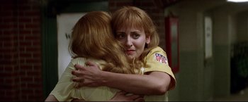 Movie still from “A League of Their Own” (1992), directed by Penny Marshall – Two women hugging each other in a room; Close Up shot, Over the shoulder angle