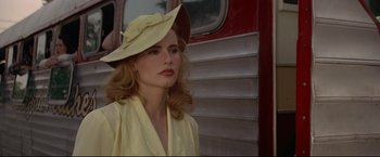 Movie still from “A League of Their Own” (1992), directed by Penny Marshall – A woman wearing a yellow dress and a yellow hat; Close Up shot, Over the shoulder angle