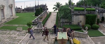 Movie still from “Airport '77” (1977), directed by Jerry Jameson – A group of people standing around a water fountain; Extreme Wide shot, High angle