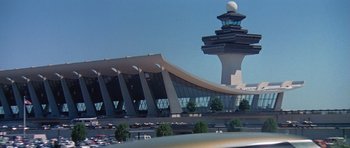 Movie still from “Airport '77” (1977), directed by Jerry Jameson – An air traffic control tower and a parking lot; Extreme Wide shot, Low angle