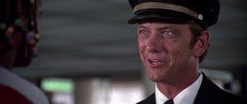 Movie still from “Airport '77” (1977), directed by Jerry Jameson – A person wearing a hat; Close Up shot, Low angle