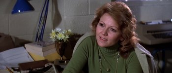 Movie still from “Airport '77” (1977), directed by Jerry Jameson – A person sitting at a table; Close Up shot, Over the shoulder angle