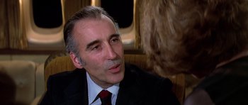 Movie still from “Airport '77” (1977), directed by Jerry Jameson – A person wearing a suit and tie; Close Up shot, Over the shoulder angle