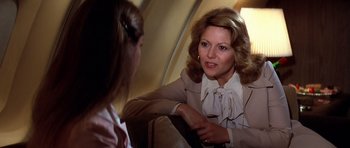 Movie still from “Airport '77” (1977), directed by Jerry Jameson – A woman talking to another woman on a couch; Close Up shot, Over the shoulder angle