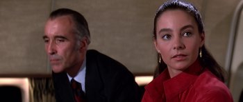 Movie still from “Airport '77” (1977), directed by Jerry Jameson – A man and a woman sitting next to each other; Close Up shot, Over the shoulder angle