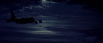 Movie still from “Airport '77” (1977), directed by Jerry Jameson – An airplane is flying in the sky at night; Extreme Wide shot, Low angle