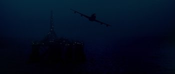 Movie still from “Airport '77” (1977), directed by Jerry Jameson – An airplane is flying low over the ocean; Extreme Wide shot, Low angle