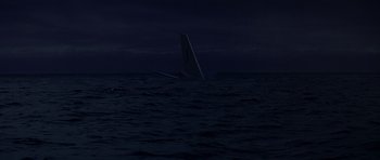 Movie still from “Airport '77” (1977), directed by Jerry Jameson – A sailboat in the middle of the ocean at night; Extreme Wide shot, High angle