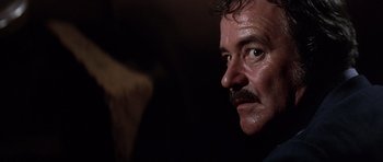 Movie still from “Airport '77” (1977), directed by Jerry Jameson – A person with a mustache; Close Up shot, Low angle