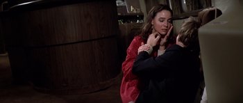 Movie still from “Airport '77” (1977), directed by Jerry Jameson – A woman sitting on the ground with a man; Close Up shot, High angle