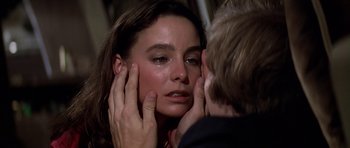 Movie still from “Airport '77” (1977), directed by Jerry Jameson – A woman is crying while being comforted by a man; Close Up shot, Over the shoulder angle