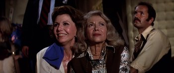 Movie still from “Airport '77” (1977), directed by Jerry Jameson – Two older women are looking up at the sky; Close Up shot, Low angle