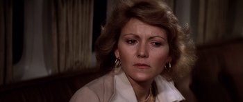 Movie still from “Airport '77” (1977), directed by Jerry Jameson – A person wearing a white shirt; Close Up shot, Over the shoulder angle