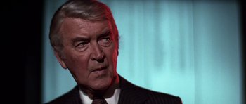 Movie still from “Airport '77” (1977), directed by Jerry Jameson – An older man wearing a suit and tie; Close Up shot, Low angle