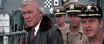 Movie still from “Airport '77” (1977), directed by Jerry Jameson – A group of men standing next to each other in uniform; Close Up shot, Over the shoulder angle