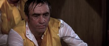 Movie still from “Airport '77” (1977), directed by Jerry Jameson – A person wearing a yellow shirt; Close Up shot, Low angle