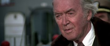 Movie still from “Airport '77” (1977), directed by Jerry Jameson – An older man wearing a fur coat looking into the distance; Close Up shot, Low angle