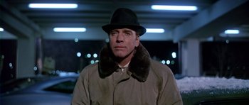 Movie still from “Airport” (1970), directed by George Seaton – A man wearing a hat and a coat; Close Up shot, Low angle