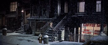 Movie still from “Airport” (1970), directed by George Seaton – A fire hydrant in front of stairs in the snow; Wide shot, High angle