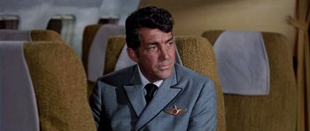 Movie still from “Airport” (1970), directed by George Seaton – A person wearing a suit and tie; Close Up shot, Low angle