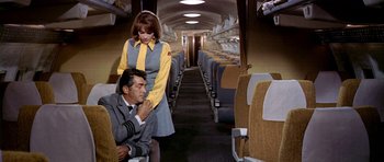 Movie still from “Airport” (1970), directed by George Seaton – A man and a woman on a train looking at each other; Medium shot, High angle