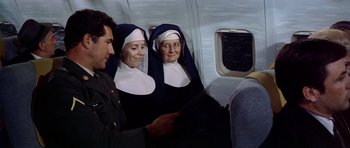 Movie still from “Airport” (1970), directed by George Seaton – Two nuns sitting next to each other on an airplane; Medium shot, High angle