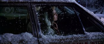 Movie still from “Airport” (1970), directed by George Seaton – A woman sitting in the driver's seat of a car; Close Up shot, High angle