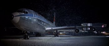 Movie still from “Airport” (1970), directed by George Seaton – An air plane on an air port run way; Extreme Wide shot, High angle
