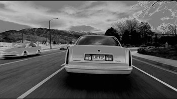 Movie still from “Better Call Saul” (2015), created by Vince Gilligan – A black - and - white photo of a car on the road; Wide shot, Low angle