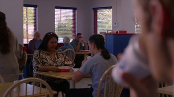 Movie still from “Better Call Saul” (2015), created by Vince Gilligan – A group of people sitting at a table in a restaurant; Medium shot, Over the shoulder angle