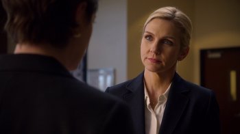 Movie still from “Better Call Saul” (2015), created by Vince Gilligan – A woman wearing a suit looking at another woman in front of a mirror; Close Up shot, Over the shoulder angle