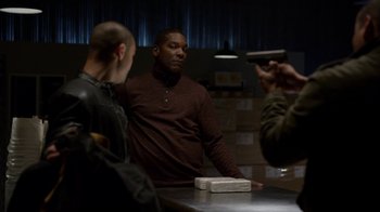 Movie still from “Better Call Saul” (2015), created by Vince Gilligan – A man standing in front of two other men holding a gun; Medium shot, Over the shoulder angle