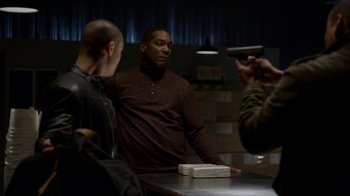 Movie still from “Better Call Saul” (2015), created by Vince Gilligan – A man standing in front of two other men holding a gun; Medium shot, Over the shoulder angle