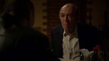 Movie still from “Better Call Saul” (2015), created by Vince Gilligan – An older man sitting in front of another man at a table; Close Up shot, Over the shoulder angle