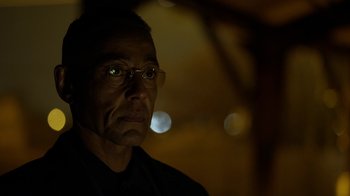 Movie still from “Better Call Saul” (2015), created by Vince Gilligan – A person wearing glasses and a black shirt; Close Up shot, Low angle