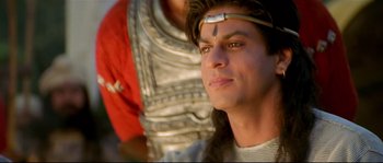 Movie still from “Asoka” (2001), directed by Santosh Sivan – A person wearing a costume; Close Up shot, High angle