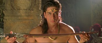 Movie still from “Asoka” (2001), directed by Santosh Sivan – A person wearing a necklace; Close Up shot, High angle