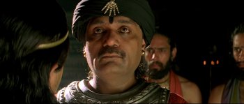 Movie still from “Asoka” (2001), directed by Santosh Sivan – A person wearing a turban; Close Up shot, Low angle