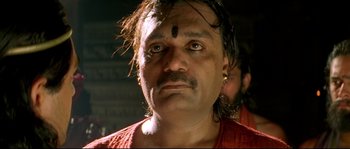Movie still from “Asoka” (2001), directed by Santosh Sivan – A person wearing a red shirt; Close Up shot, Low angle