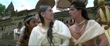 Movie still from “Asoka” (2001), directed by Santosh Sivan – An older woman and two young men are talking to each other; Close Up shot, Over the shoulder angle