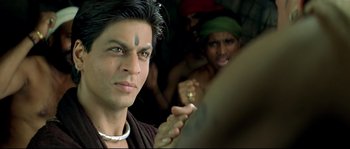 Movie still from “Asoka” (2001), directed by Santosh Sivan – A person with a face tattoo on their face; Close Up shot, Over the shoulder angle