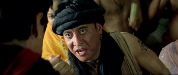 Movie still from “Asoka” (2001), directed by Santosh Sivan – A person wearing a hat; Close Up shot, Low angle