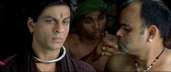 Movie still from “Asoka” (2001), directed by Santosh Sivan – A group of men sitting next to each other in a room; Close Up shot, Over the shoulder angle