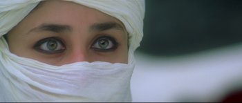 Movie still from “Asoka” (2001), directed by Santosh Sivan – A person wearing a head covering; Extreme Close Up shot, High angle