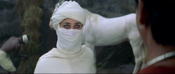 Movie still from “Asoka” (2001), directed by Santosh Sivan – A woman wearing a white cloth wrapped around her face; Close Up shot, High angle