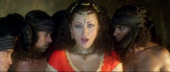 Movie still from “Asoka” (2001), directed by Santosh Sivan – A woman with long hair and a necklace; Close Up shot, Overhead angle