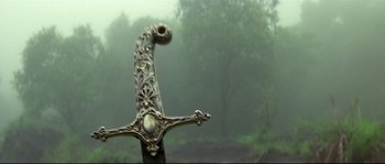 Movie still from “Asoka” (2001), directed by Santosh Sivan – An ornate sword in the middle of a foggy forest; Close Up shot, Low angle