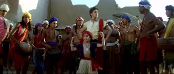 Movie still from “Asoka” (2001), directed by Santosh Sivan – A group of people in costume in a desert setting; Wide shot, Low angle